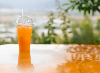 Glass of orange juice on the table outdoor