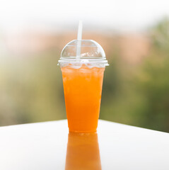 Glass of orange juice on the table outdoor