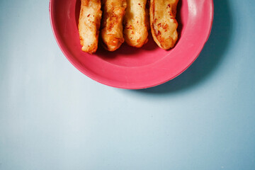 banana fried on red plate isolated on blue background