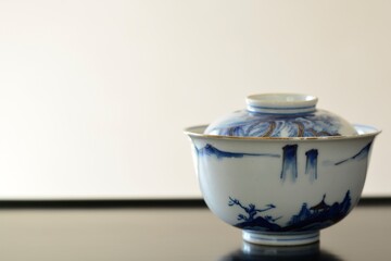 picture rice bowl. put on a Japanese lacquer shelf. This is a very fine example of Japanese traditional antique “ imari ware ”. blurred background soft focus image.