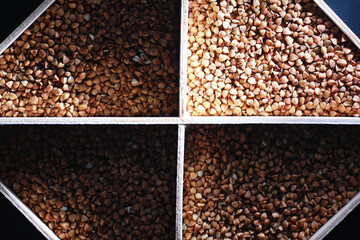 A set of grain cereals. Rice, buckwheat and millet groats in a wooden tray. A grocery set of...