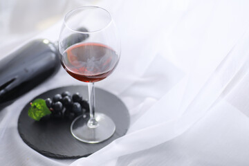 Glass with grape red semi-dry wine. Valentine's day concept background. Gift for the holiday. Sweet sparkling wine.