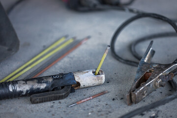 Selective focus shot of a welding ground clamp and electrode holder or stinger