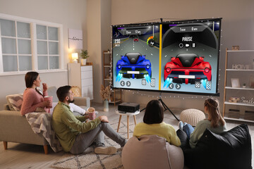 Friends playing video games on big screen at home