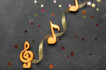 Music notes and Christmas decor on dark background