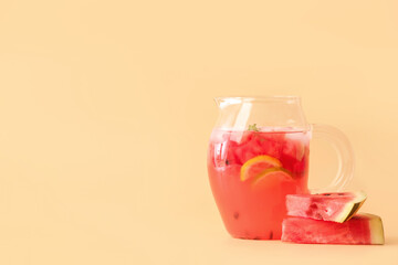 Jug of cold watermelon lemonade on color background