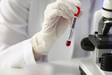 Scientist studying sample in laboratory
