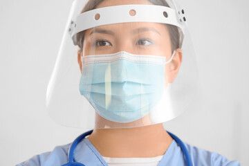 Fototapeta na wymiar Portrait of female Asian doctor wearing medical mask in clinic