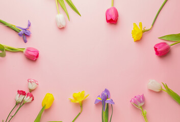 Obraz na płótnie Canvas Frame made of beautiful flowers on color background