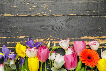 Beautiful flowers on dark wooden background