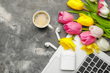 Composition with laptop, coffee and flowers on grunge background