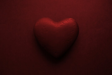 Valentines day background. Black textured heart, isolated on black.