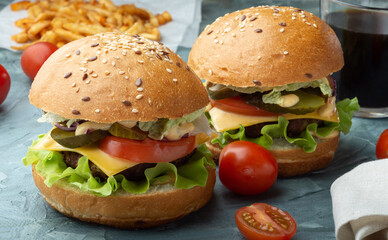 Burgers with beef patty and drink. Burgers with French fries.