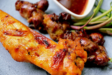 Grilled chicken offal and chicken grilled on plate.