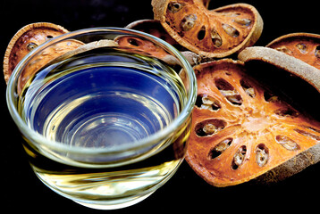 Tea and slices of dried bael fruit.