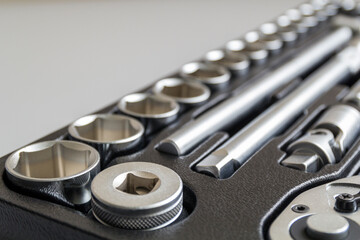 Set of tools closeup - wrench heads, nozzles the screwdriver in case. Professional instrument. Selective focus.