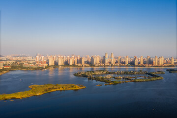 Fototapeta na wymiar Aerial view of city skyline and natural park with lakes in Jimei District in Xiamen