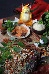 Indian spices on a wooden table in ceramic and wooden utensils