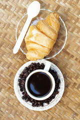 cup of coffee with croissant