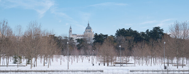 Almudena Cathedral view from Madrid Rio park after Filomena snowstorm. Panoramic photo. January 2021 in Madrid, Spain.