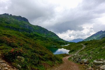 path around a beautiful clear mountain lake while hiking