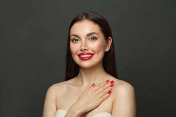 Fashion model woman with red nails on black background