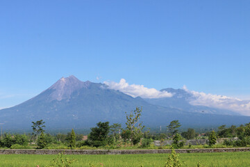 Obraz premium Aerial view of Mount Merapi Landscape with rice field and village in Yogyakarta, Indonesia Volcano Landscape View