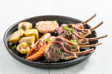 Roasted ribs of lamb on the white table