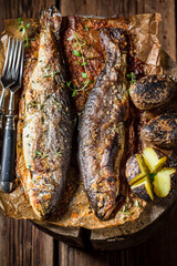 Closeup of trout fish roasted with potatoes and butter