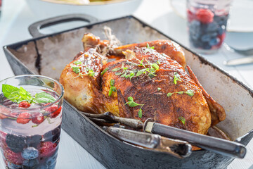 Closeup of roasted chicken in casserole in garden