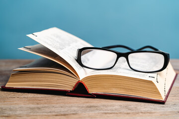 glasses lie on an open book