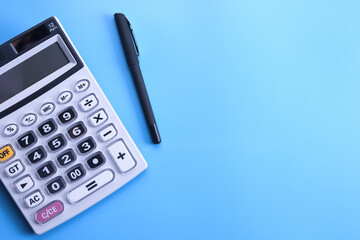 Calculator keypad on a blue background. Top view. Copy space