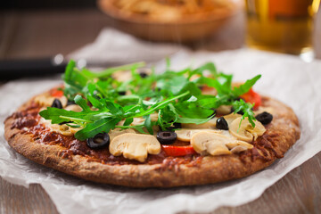 Pizza with Cheese, Tomatoes, Champignon, Olives and Arugola.