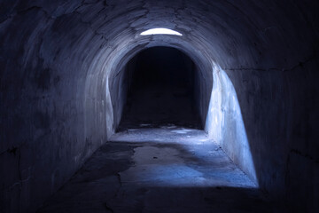 A sunlit exit from a dark dungeon. Light at the end of the tunnel, exit from the underground passage.