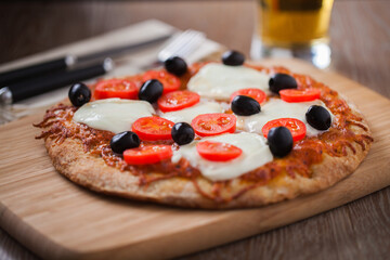 Pizza with Fresh Cheese, Cherry Tomatoes and Olives and Beer