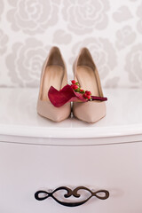 Wedding accessories: bride's shoes, rings and boutonniere, bouquet