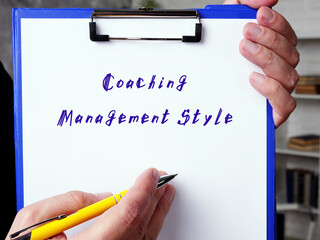 Business concept meaning Coaching Management Style with sign on the sheet.