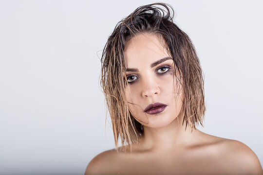 beautiful girl with wet hair on a white background