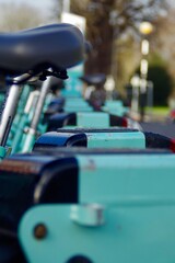 turquoise bicycles parked in a ro