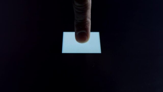 Human finger is pressing a digital button on a glowing touchscreen. Futuristic microprocessor is starting the operation of the computer program. Machine learning and artificial intelligence.