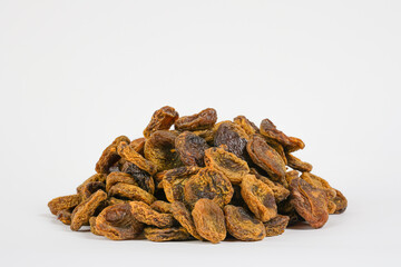 Dried plums on white background. Organic dried  fruits. Dry prunes.  Studio light. Copy space.  Studio photo.
