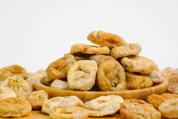 Natural dried figs on white background.  Organic dry fruits. Studio light. Copy space. Health, organic concept. 