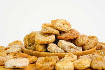Fototapeta na wymiar Close up of dried figs. Natural dried figs on white background. Organic dry fruits. Studio light. Copy space. Health, organic concept. 