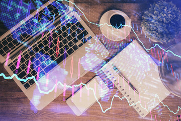 Financial market graph and top view computer on the desktop background. Double exposure. Investment concept.