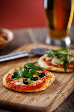 Mini Pizzas served on Wooden Board. High quality photo.