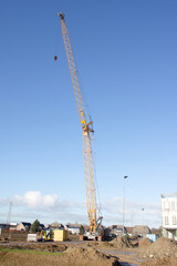 Fototapeta na wymiar Large yellow crane on construction site