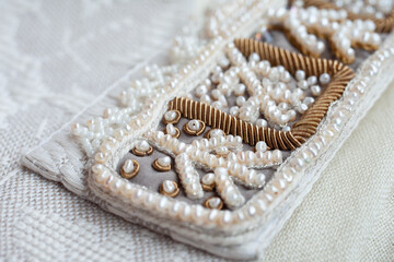 Embroidery of a traditional russian headdress in the technique of pearl sewing.