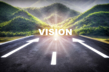 Vision word behind arrow sign for give direction on empty asphalt road with sunrise on mountain...