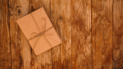 A lot of envelopes from kraft paper tied with string on a wooden background