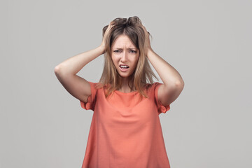 Portrait of concerned, worried and anxious blond girl, grab head and panicking, staring alarmed, feel scared and nervous